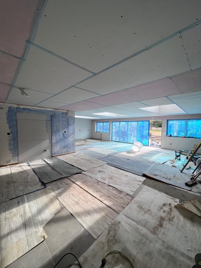 Open-plan interior stripped back and re-plastered on a Chislehurst project